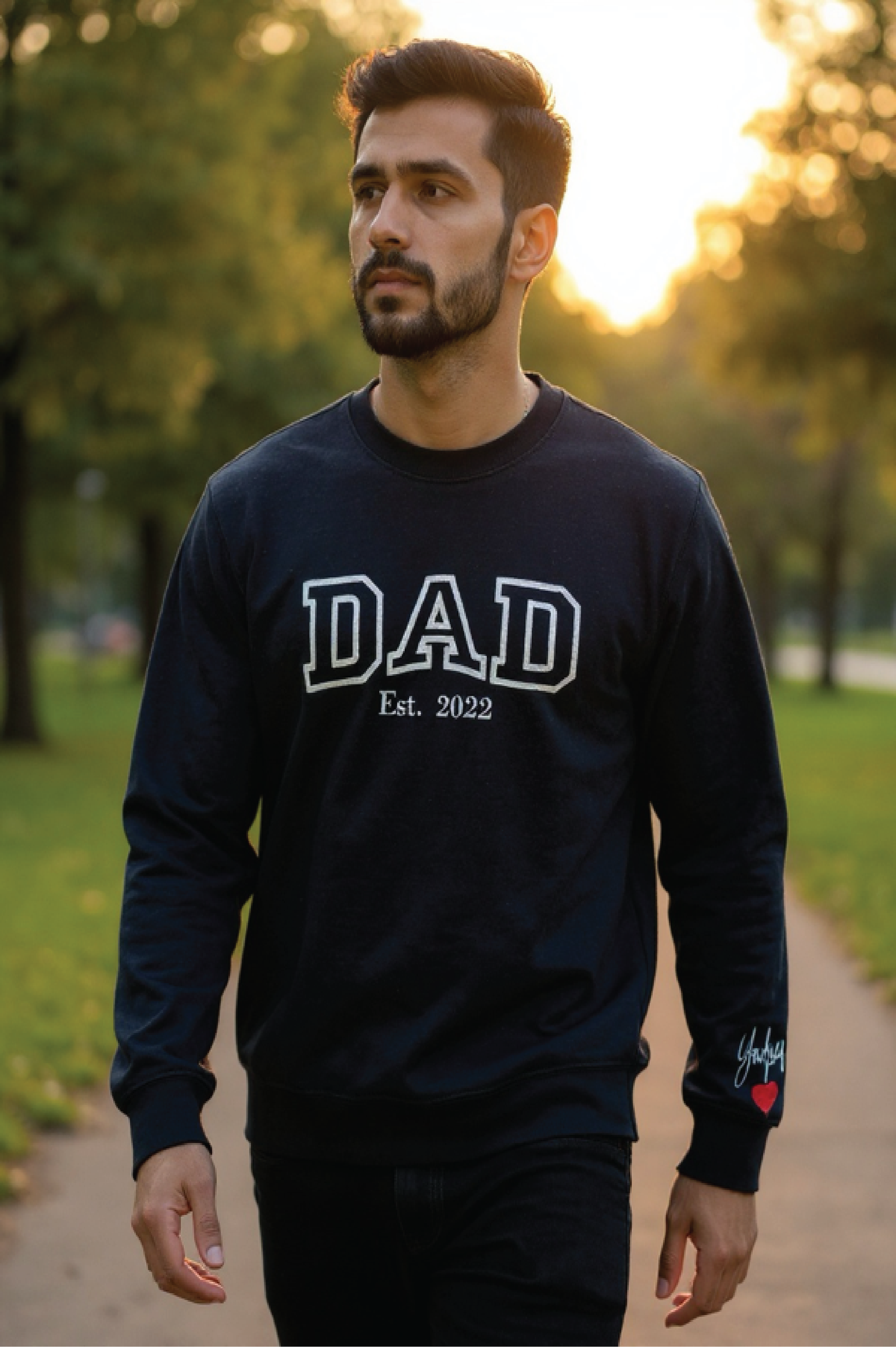 Man wearing a navy blue sweatshirt with 'DAD Est. 2022' text, standing outdoors.

Dad custom embroidered sweatshirt with kids’ names on sleeve – black pullover

Personalized dad sweatshirt with child name embroidered on sleeve – gray crewneck